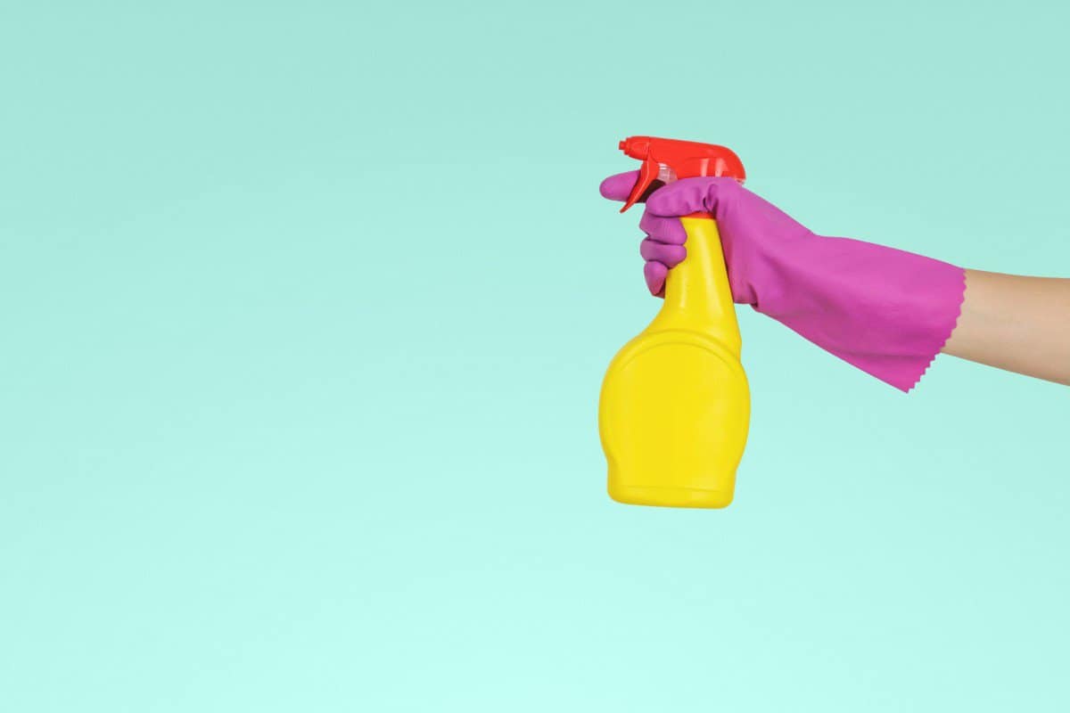 person spraying cleaner