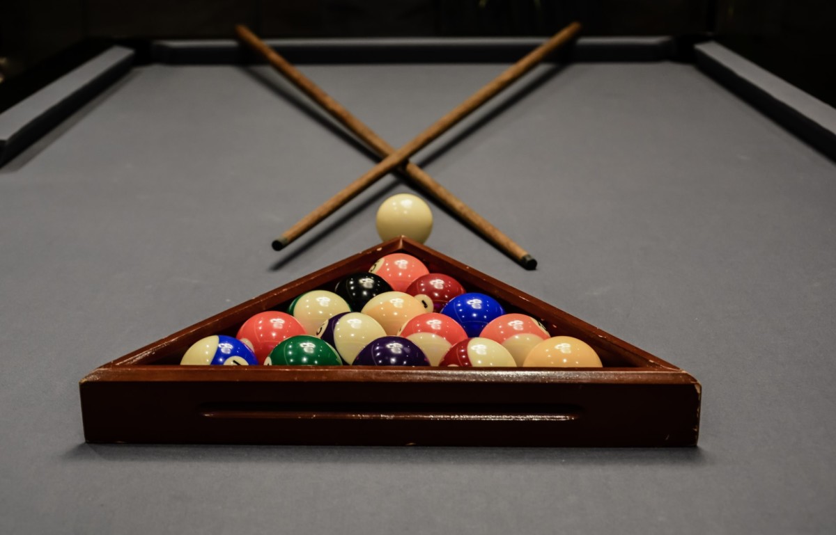 rack of pool balls in triangle rack on table